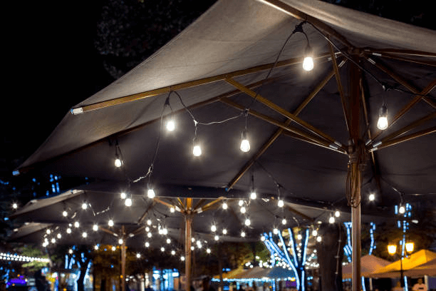 How will you add solar string lights to the patio umbrella?